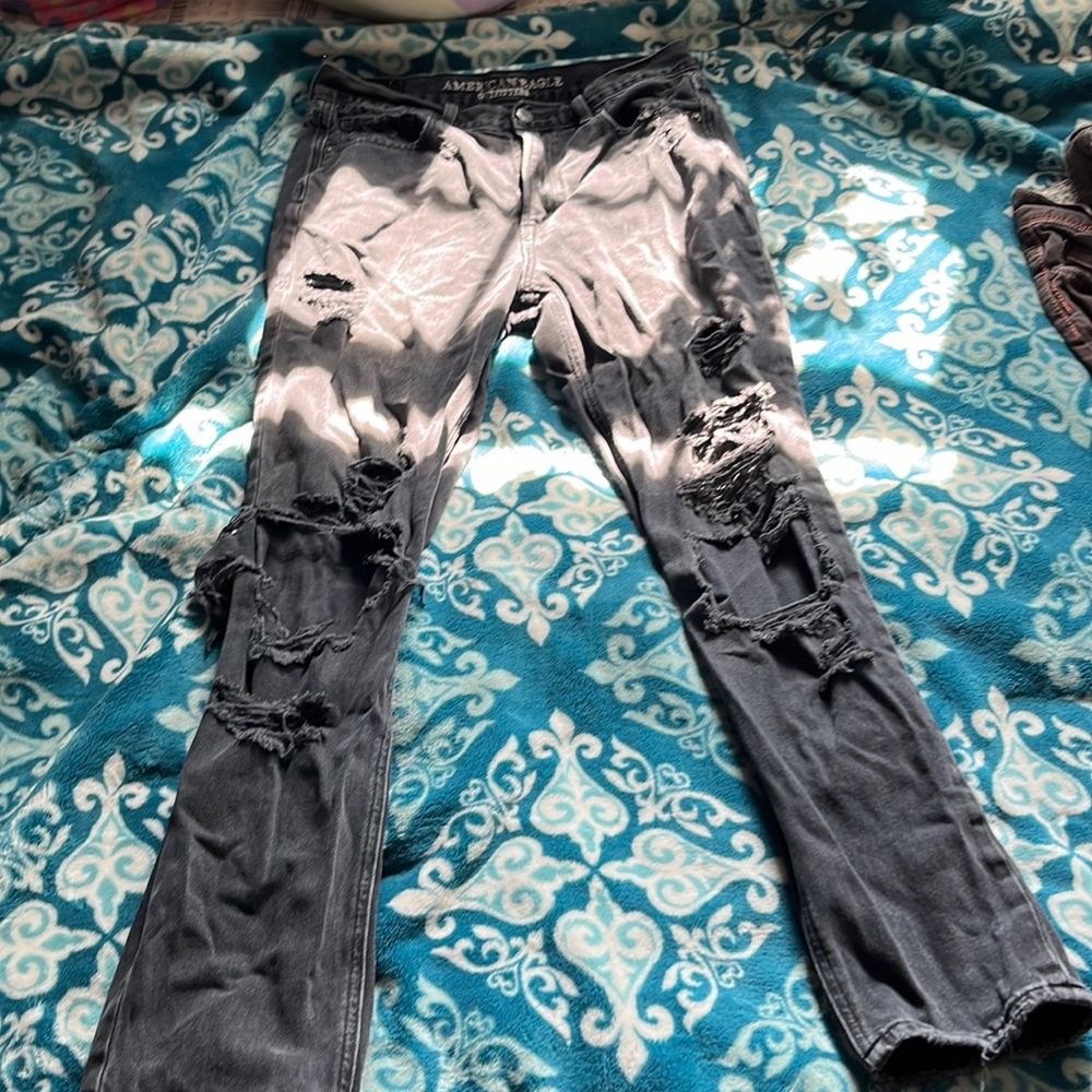 Black pants with holes and silver buttons